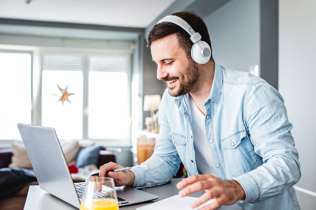 A photo of a person on their computer.